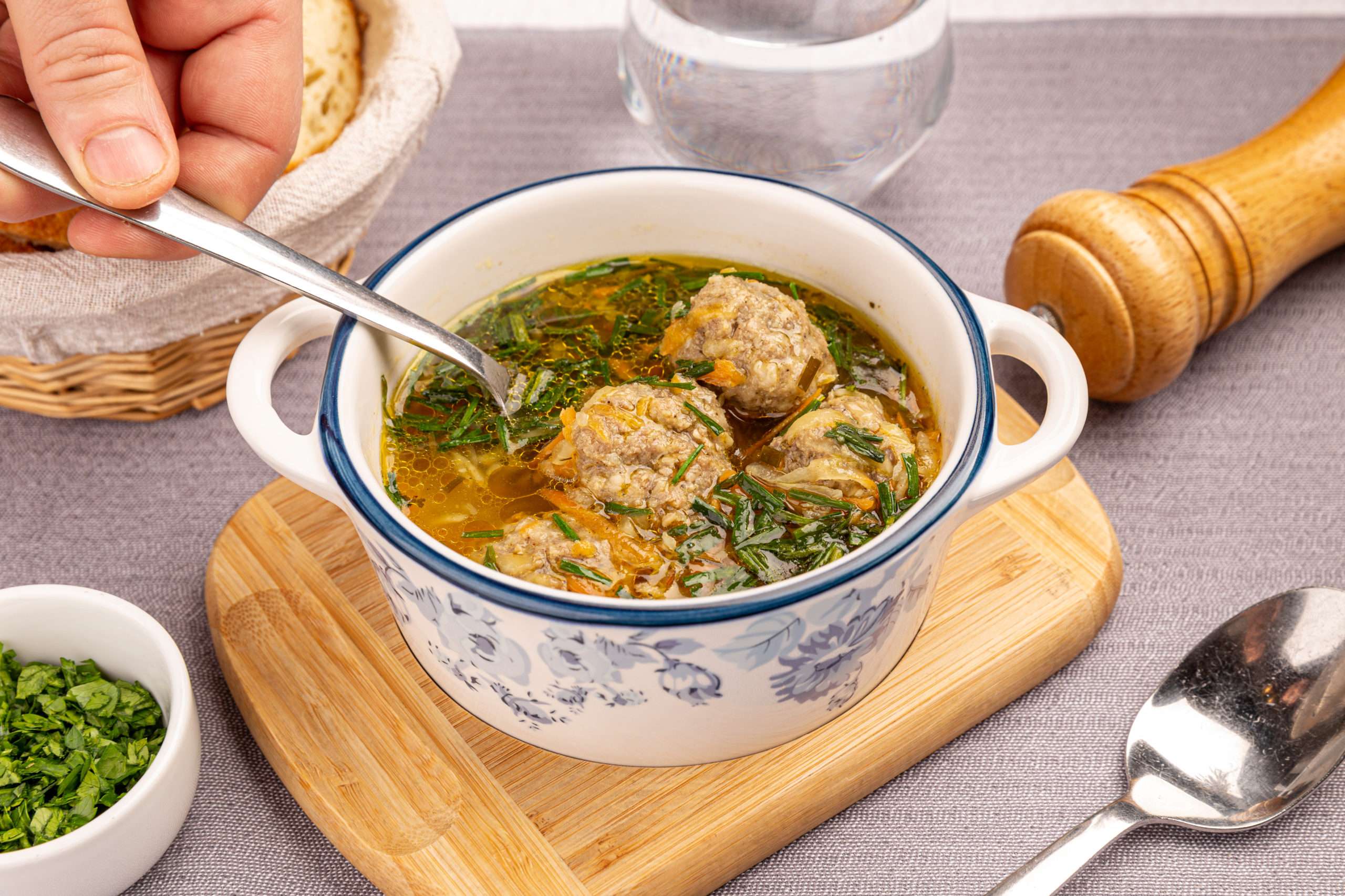 Soup with meatballs and vegetables on the restaurant table